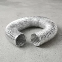 Flexible aluminum duct hose coiled on a concrete floor, ends open and ready for ventilation use